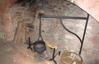 Medieval cooking pot in fireplace